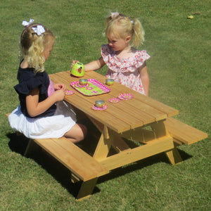 Kids sitting at a BBQ table